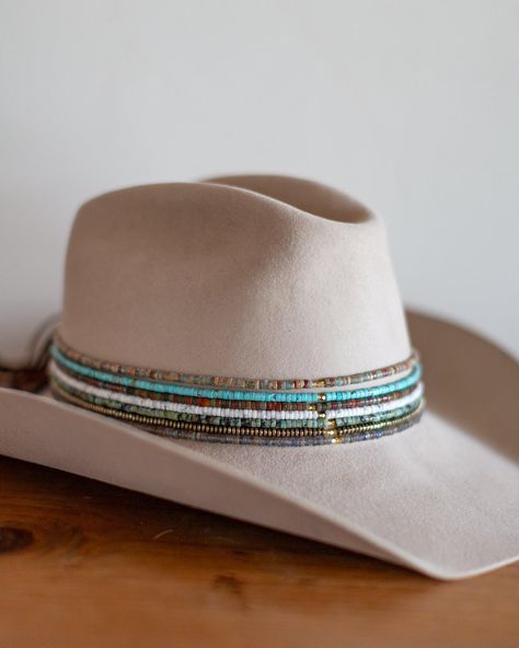 The perfect addition to any hat, our beaded hat bands feature a variety of semi-precious gemstones with leather ties for an adjustable closure to fit any hat. Dimensions: 21" beaded length before leather ties Material: Various Stones/Beads, Leather Cording Hardware: Gold Plated Jump Rings and Crimp Beads Closure: Leather Ties - brown for all stone options except pyrite, which uses black Stone Options: African TurquoiseTurquoiseLabradoritePyriteWhite HowlitePicasso JasperAqua Terra Jasper Handmad Custom Cowboy Hats, Cowboy Hat Bands, Beaded Hat Bands, Hat Bands, Beaded Hat, Hat Accessories, Crimp Beads, Western Hats, Crossbow