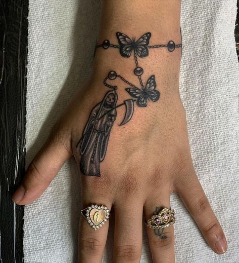 31 Santa Muerte Tattoos: The Meaning Behind This Powerful Design - Body Artifact Santa Muerte Hand Tattoo, Small Santa Muerte Tattoo, Latina Tattoo Ideas Mexican Art, Santisima Muerte Tattoo, Santa Muerte Tattoo For Women, Santa Muerte Nails, Santa Muerte Drawing Tattoo, Santa Muerte Tattoo Stencil, Santa Muerte Drawing