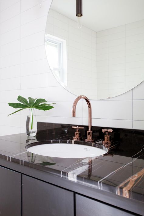 Keeping the main elements of this bathroom sleek and simple, like the frameless round mirror, white tile and minimalist light fixture, allow accent pieces, like this beautiful rose gold faucet, to shine. Rose Gold Faucet, Shiplap Wainscoting, Rose Gold Bathroom, Midcentury Modern Bathroom, Gold Bathroom Faucet, Gold Faucet, Zen Bathroom, Trough Sink, White Subway Tiles