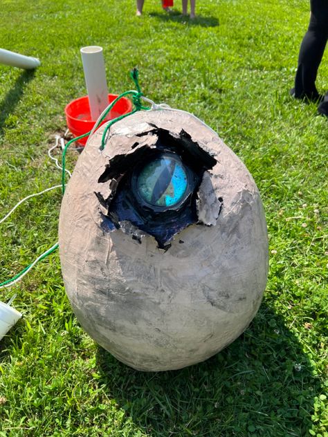 Large oval egg, tan in color. The egg appears to be broken at the top right with a 3D dinosaur eye peering of the crack. Paper Mache Dinosaur, Valentine's Boxes, Dnd Party, 7 Birthday, 3d Eye, Dinosaur Egg, Dinosaur Eggs, Trunk Or Treat, Princess Birthday Party