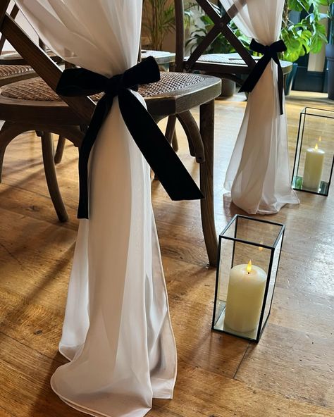 SIDE SWEEP 💫 For when you want something a little special for your aisle, try a gorgeous side sweeping drape complete with velvet bow 🖤 @ambienceleeds @the_faversham . . . . #weddings #weddingday #weddingideas #weddinginspo #weddingdecor #weddingdecorideas #weddingstyle #weddingtrends #bows #bowtrend #chairdecor #weddingchairs #blacktiewedding #ceremonydecor #aislestyle #weddingaisle #leedswedding #leedsbride #weddingstylist #venuestylist #stylishwedding Bows On Aisle Chairs, Bow Aisle Decor, Black And White Aisle Decorations, Bow Aisle Markers, Black Chair Sashes Wedding, Aisle Bows For Wedding, Chair Wedding Decorations, Bow Wedding Decor, Wedding Chapel Ideas