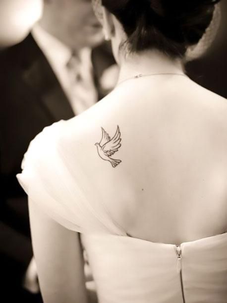 An elegant tattoo of a cute dove inked on the shoulder blade. Color: Black. Tags: Cute, Elegant Detailed Dove Tattoo, Simple Dove Tattoo, Small Dove Tattoos, Dove Silhouette, Pigeon Tattoo, Small Bird Tattoos, Dove Tattoo Design, Girl Shoulder Tattoos, Tattoo Coverup