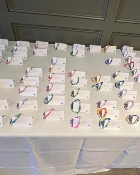 For my wedding of 120 guests, I made a friendship bracelet with each guest’s name and used bead colors unique to each person. We put each bracelet with the name card. I also made bracelets for the tables as decor, and put things like song lyrics, swiftie things, inside jokes, child names, or pet names at tables based on the seating chart. I did this as a Swiftie but was pleasantly surprised at how much all guests loved the bracelets- non-swifties included! I had so much fun making these brace... Friendship Bracelet Seating Chart, Bracelet Placement, Child Names, Made Bracelets, Bracelet Wedding, Name Card, Inside Jokes, Seating Chart, Seating Charts