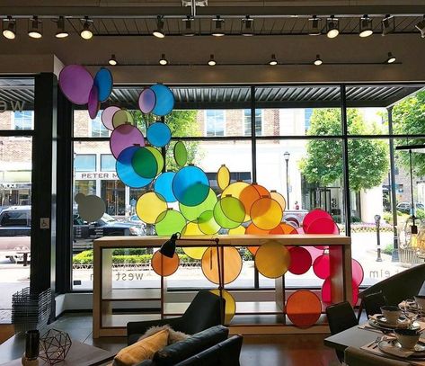 Merry & Bright window display Rainbow Window Display, Pride Window Display, Spring Window Display Ideas, Pride Display, Spring Window Display, Summer Window, Spring Window, Ceiling Art, Showroom Interior Design