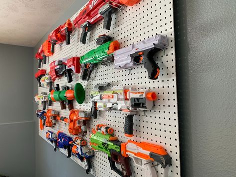 This is a great article detailing the best way to organize your Nerf guns, how to make a DIY Nerf gun wall, and what to do with all of the Nerf gun accessories. Nerf Organization Ideas, Nerf Wall, Toy Closet Organization, Nerf Storage, Toy Organization Ideas, Cucumber Trellis Diy, Trellis Diy, Wall Images, Cucumber Trellis