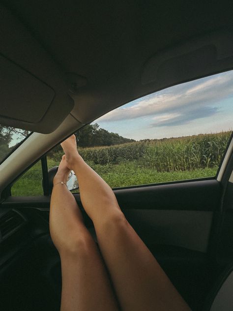 Girl’s feet hanging out of the car window while driving on a back country road Head Out Of Car Window Aesthetic, April Core, Concert Vibes, How To Lean Out, Picture Stand, Picture Windows, Granola Girl, Aesthetic Gif, Car Photography