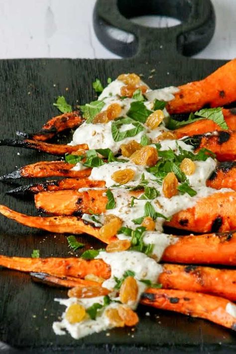 Grilling season is in full swing, and this summer, I’m determined to eat less meat and embrace more grilled vegetables. And these Grilled Mediterranean Carrots are the perfect dish to meet my goal.Grilling the carrots caramelizes the starches in the carrots, making them tender and just sweet enough to forget you’re eating vegetables. This, combined with the incredible yogurt sauce results in an incredible dish, that’ll I’ll be making over and over again this summer. Give it a try, you… Vegan Recipes Broccoli, Mediterranean Grilled Chicken, Greek Turkey Burgers, Moroccan Carrots, Grilled Carrots, Homemade Flatbread, Flavor Enhancers, Summer Grilling Recipes, Grilling Season