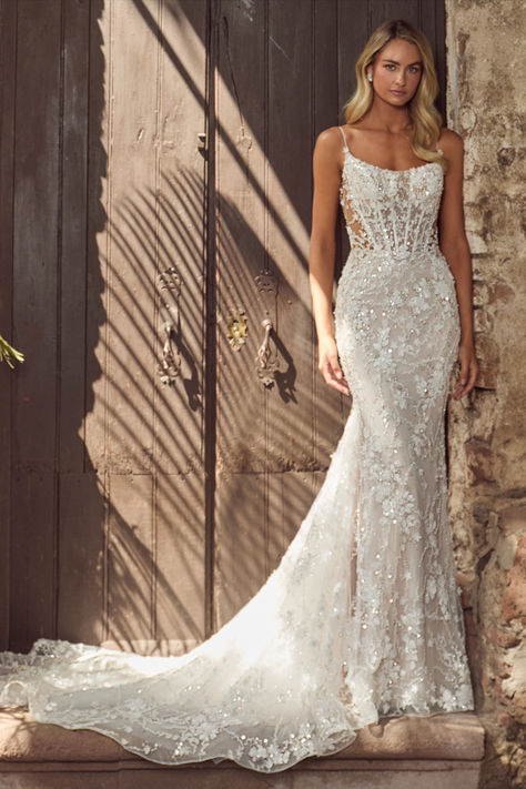 In this wedding dress with an overskirt,there’s no doubt in our minds that you’ll evoke the same majesty of Hera and feel just as beautiful as the goddess herself.Featuring a sheath silhouette adorned with sparkling sequins and intricate lace,this dress transforms with a detachable overskirt,making the arrival at the reception even more breathtaking.Her spaghetti straps create an airy feel, while her low back exudes allure, allowing brides to glide down the aisle while  blending sophistication. Strappy Sheath Wedding Dress, Mermaid Wedding Dress Corset Top, Lace Sparkly Wedding Dress, Fitted Wedding Dress Sparkle, Floral Lace Wedding Dress Fitted, Wedding Dresses With Overskirt, Tight Wedding Dress Open Backs, Wedding Dresses With Sparkle, Tight Fitting Wedding Dresses