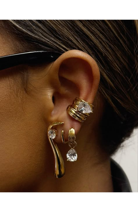 Designed in collaboration with iconic eyewear brand Dezi, these stunning huggie earrings are complete with pear-cut cubic zirconia stones 3/8" drop; 1/8" width Snap-post closure Goldtone or silvertone plate/cubic zirconia Imported 90s Earrings Style, Edgy Jewelry Aesthetic, Maximalist Earring Stack, Midi Ear Piercing, Chunky Earring Stack, Silver Stacked Earrings, Delicate Ear Piercings, Kim Kardashian Jewelry, Winter Jewelry Trends