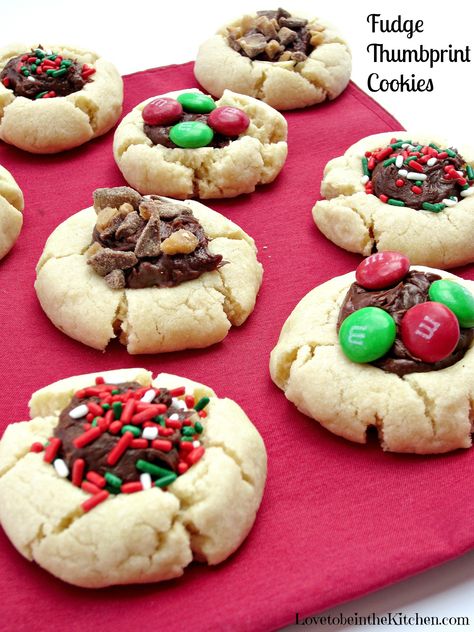 Fudge Thumbprint Cookies- Easy, pretty and so yummy! #christmas Fudge Thumbprint Cookies, Reese’s Thumbprint Cookies, Chocolate Thumbprint Cookies Kisses, Holiday Cookie Exchange Recipes, Thumbprint Cookies With Chocolate Center, Kaufman's Thumbprint Cookies, Cookies 2023, Kitchen Italian, Holiday Boards