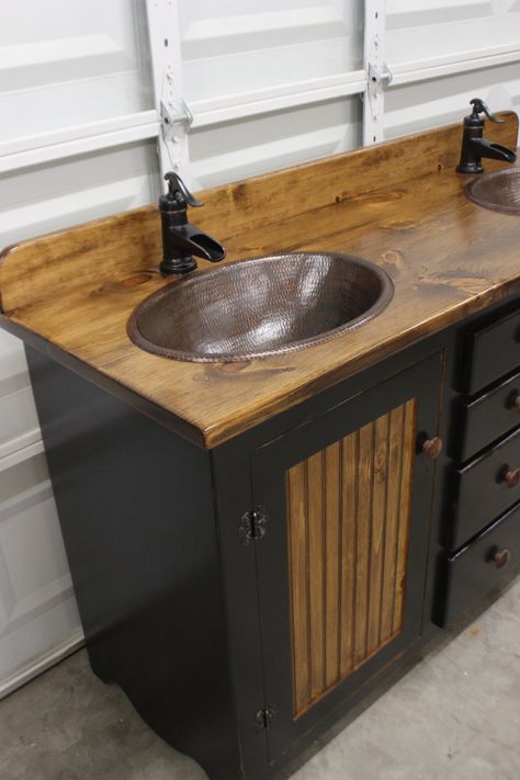 This black and stained Rustic Farmhouse Double Bathroom Vanity is at home in a rustic bathroom or a farmhouse style home. It is from our Rustic Farmhouse line of Bathroom Vanities 60 inches wide 34 inches high 21 inches deep COPPER SINKS AND FAUCETS ARE INCLUDED IN THIS PRICE. This vanity is hand-made in our shop in East Texas. The cabinet is all wood, furniture-grade pine, finished in a special way to hold up well in the bathroom moisture. This color is hand-rubbed, antiqued black. We can finis Rustic Sink Vanity, Galvanized Bathroom Sink, Primitive Bathrooms Farmhouse Style, Old Dresser Bathroom Vanity, Country Rustic Bathroom Ideas, Bathroom Vanity Rustic, Diy Sink Vanity, Southwestern Bathroom, Rustic Bathroom Sink