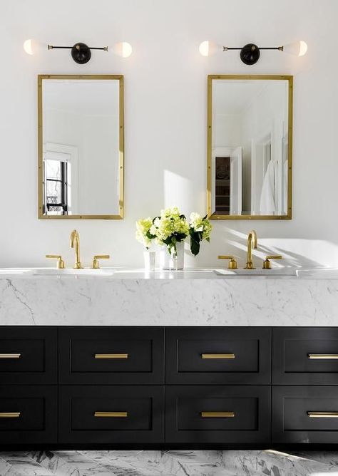 Stunning contemporary black, white and gold bathroom boasts white walls holding two mounted Rivet Medicine Cabinets in Antiqued Brass from Restoration Hardware hung above a black double washstand topped with thick white marble countertops fitted with polished brass gooseneck faucets and shaker cabinets finished with brass vanity pulls as gray and white marble herringbone floor tiles are illuminated by two black and white 2 light sconces. Decorate House, Bad Inspiration, Gold Bathroom, Powder Rooms, House Interiors, Bathroom Renos, House Goals, House Tour, Guest Bathroom