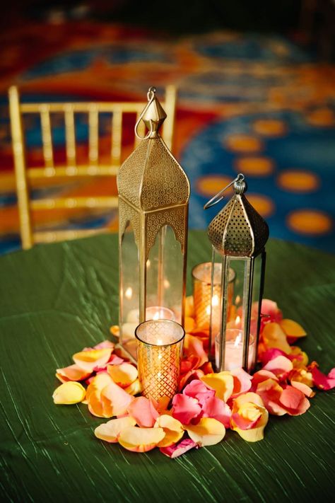 Garba, Sangeet, Mehndi, Lantern, Candle, Flower Petals, orange, yellow, flower, lotus, bronze, candle, green Indian Lantern Centerpieces, Mehndi Decor Centerpieces, Indian Wedding Centerpieces Diy, Indian Wedding Table Decorations Centerpiece Ideas, Mehndi Centerpieces Diy, Mendhi Centerpieces Table Settings, Indian Lantern Decor, Mehndi Table Decorations, Sangeet Table Centerpieces