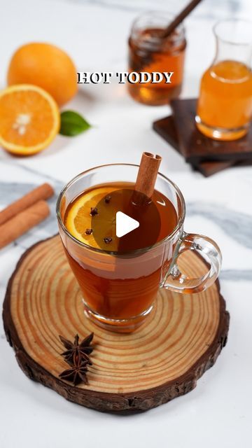 NIKITA SHAH | FOOD & TRAVEL on Instagram: "Hot Toddy

There’s nothing like cozying up with a classic hot toddy when it’s pouring outside. This soothing, comfy drink is my go-to so try it today & enjoy the rainy day vibes! 

Ingredients:
¾ cup Water
1 tsp Black Tea
1 Star Anise
1 Cinnamon Stick
2-3 Cloves
2 tsp Honey
¼ cup Orange Juice
1 Orange Round

Method:
- In a saucepan bring water to a boil, add in the black tea, star anise, cinnamon stick and let it simmer 
- In a glass pour honey & orange juice 
- Strain and pour the black tea into the glass mug 
- Garnish with an orange round pierced with cloves (as shown in the video) and a cinnamon stick and sip away!

#hottoddy #blacktea #orangejuice #hotdrink #drinkoftheday #trending #tealovers #nonalcoholic" Rainy Day Vibes, Hot Toddy Recipe, Orange Juice Drinks, Hot Toddies Recipe, Hot Toddy, Star Anise, Glass Mug, Food Travel, Tea Recipes