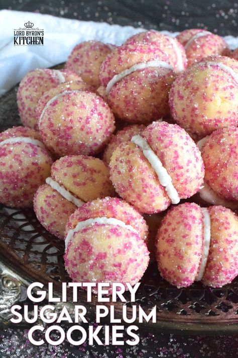 These beautiful, shimmering, Glittery Sugar Plum Cookies are the epitome of priceless luxury on a dollar store budget.The cookies are baked with a sparkling, sugary coating and sandwiched together with an easy, sweet frosting. One bite and you'll certainly have visions of these sugar plums dancing in your head on Christmas Eve night! #sugarplums #christmas #baking #cookies #glitter Plum Cookies, Sugar Plum Recipes, Old Fashioned Molasses Cookies, Plum Recipes, Sugar Plums, Berry Muffins, Sugar Plum Fairy, Crinkle Cookies, Baking Cookies