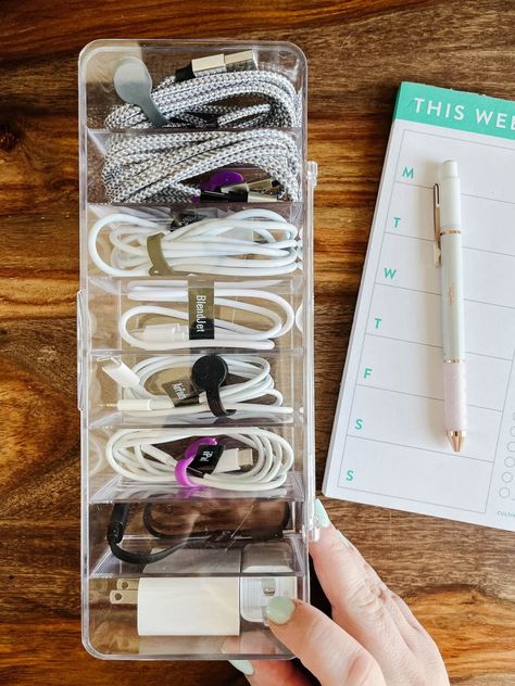 Are your charging cables and cords a tangled mess? Steal these easy ideas for organizing your cord clutter. Extra Cord Storage, Phone Cord Storage, How To Organize Chargers Cords, Organizing Electronics Cords, Charger Organizer Diy, Computer Cable Organization, Chord Organisation, Charging Cord Storage, Organize Electronic Cords