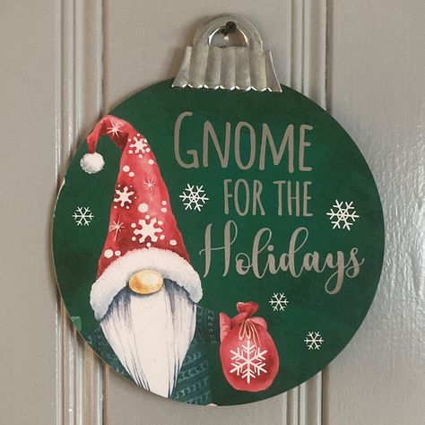 Turn You House Into A Christmas Tree With These Gorgeous Round Ornament Holiday Decoration Wall Signs. They Have A Silver Foil Leaf Sentiment That Reads Gnome For The Holidays So When You See The Words In Different Lighting The Letters Are Reflective. Has A Precious Gnome Character. Has A Galvanized Metal Top Just Like On An Ornament Measures: 12” L X 12” W Single Front Sided Design With Plain Brown Back It Is Hung Up By The Ornament Topper Piece Comes Brand New With Tag Frankenstein Halloween Decorations, Gnomes Painting, Gnome For The Holidays, Halloween Blow Molds, Door Hanger Wreath, Hanger Wreath, Gnome Ornaments, Gnome Christmas, Holiday Door