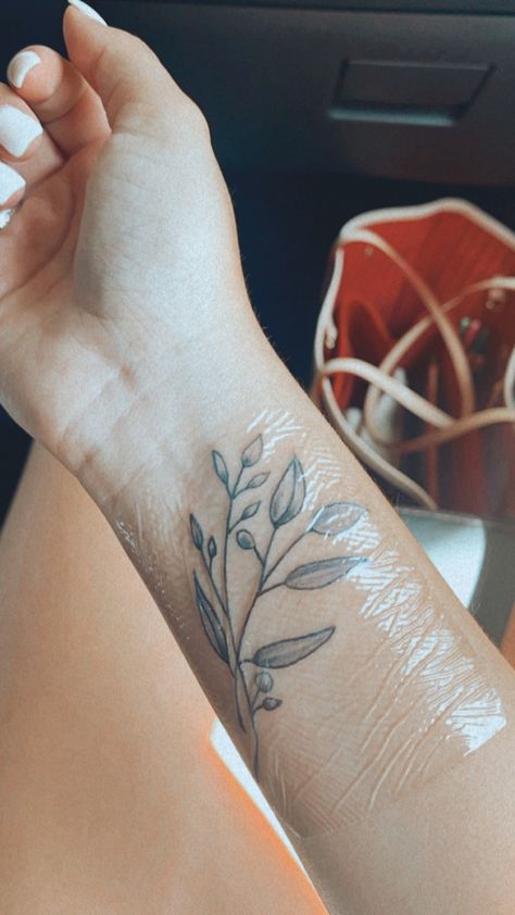 Biblical Plant Tattoos, Olive Branch Wrist Wrap Tattoo, Olive Branch Tattoo Wrapped Around Arm, Olive Branch Tattoo Forearm, Olive Branch Wrist Tattoo, Christian Floral Tattoo, Minimal Vine Tattoo Arm, Delicate Olive Branch Tattoo, Olive Branch Around Arm Tattoo