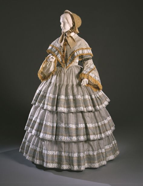 Day Dress and Capelet  Artist/maker unknown, American  Geography: Made in United States, North and Central America Date: c. 1855 Medium: Light blue, white and black silk in figured and sheer plain weave stripes; silk fringe and tassels Dimensions: Dress (Center Back Length): 54 inches (137.2 cm) Waist: 22 inches (55.9 cm) Capelet: 16 x 14 inches (40.6 x 35.6 cm) Accession Number: 1967-169-5a,b 1850s Dress, 1850s Fashion, 1860 Fashion, 19th Century Clothing, Historic Fashion, 19th Century Fashion, Old Dresses, Philadelphia Museum Of Art, Century Clothing