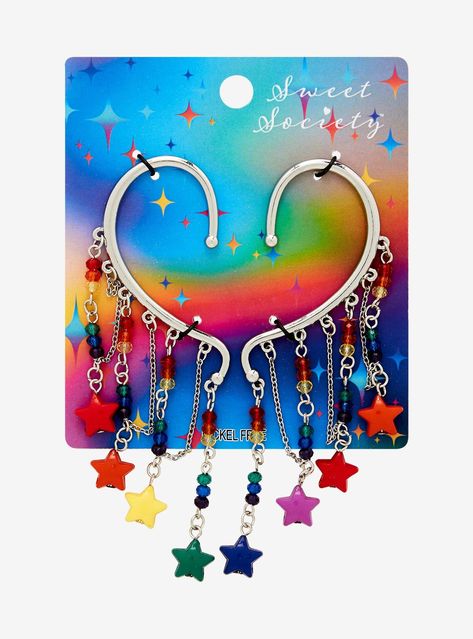 Add a sparkle of color to your look with this ear cuff set! Featuring cascading chains with rainbow beads and star charms.4'' dropsNickel-free alloy; acrylicSet of 2Imported Star Earrings Aesthetic, Silly Jewelry, Hoarding Board, Lgbtq Jewelry, Ear Cuff Diy, Alt Accessories, Weird Earrings, Emo Accessories, Cosplay Idea