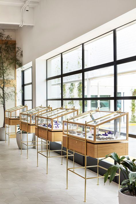 A Former Auto Garage Has Been Transformed into a Luxe New Dispensary - Metropolis Dispensary Design, Hollywood Apartment, Commune Design, Globe Light Fixture, Cement Tile Floor, Jewelry Store Design, Autocad Blocks, Pale Wood, Display Furniture