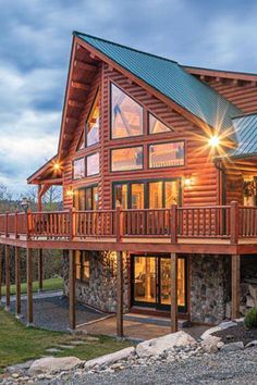 While you might assume wrap-around porches and decks are a quintessentially American concept, according to Michael Grant of Modern Rustic Homes, their origins can be traced to ancient Japan. Coventry Log Homes photo by Mark Sorenson Log Home Porch, Log Cabin Exterior Ideas, Bison Ranch, Modern Log Home, Log Homes Exterior, House Dr, Luxury Cabins, Rustic Homes, Log Home Designs