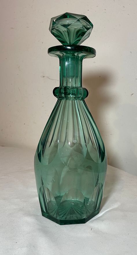 Up for sale is a nice quality antique cut crystal Moser decanter. The decanter is done in a thick cut green crystal with an exquisite silhouette and has its large matching glass stopper. The decanter is in good antique condition and measures 11 inches tall by 4 1/2 inches wide. It has a chip at the decanter lip and at the small point of the stopper as shown in last photos. Crystal Glassware Antiques, Vintage Glass Bottles, Glass Wear, Genie In A Bottle, Antique Glass Bottles, Nostalgic Images, Antique Green, Crystal Decanter, Crystal Glassware