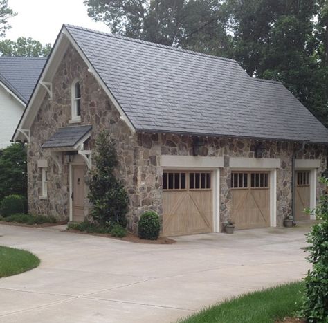 Stone garage with limestone headers and cerused doors Stone Garage, Canvas Awnings, Garage Door Types, Carriage House Garage, Carriage House Plans, Appliance Garage, Garage Exterior, Garage Addition, Garage Door Design