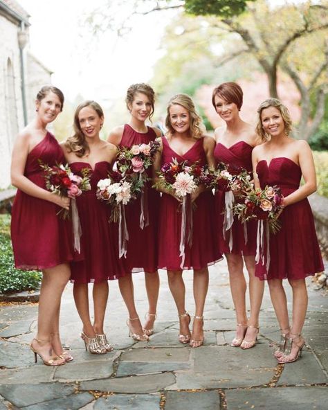 The bridesmaids chose chiffon J.Crew dresses in different cuts but the same ruby shade. Unique Bridesmaid Dresses, Red Bridesmaid, Crystal Wedding Dress, Burgundy Bridesmaid, Mismatched Bridesmaids, Wedding Dress Guide, Mismatched Bridesmaid Dresses, Red Bridesmaids, Red Bridesmaid Dresses