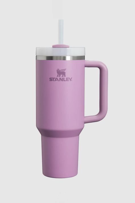 This Stanley Quencher H2.0 FlowState 40oz Travel Tumbler in Lilac is just what you need for all-day hydration. Take it with you to a high-intensity workout or on an extra-long commute to keep your drink cold for hours. The lid features a rotating cover with three positions: a straw opening, a wide mouth for drinking, and a full-cover top to prevent spills. Features: Stanley Style: 10-10824-291 LILAC Color: Purple 90% Recycled 18/8 stainless steel, BPA-free Recycled stainless steel icon inside the tumbler indicates your Quencher is made from sustainable material Double-wall vacuum insulation Powder coat finish FlowState™ screw-on 3-position lid Reusable straw Comfort-grip handle Car cup holder compatible (base diameter: 3.1 inches) Dishwasher safe Dimensions: 3.86 L x 5.28 W x 12.3 H Stanley Cup Purple, Purple Stanley Cup, Purple Stanley, Copo Stanley, Purple Items, Burr Basket, Fall Basics, Basket Making, Stanley Quencher