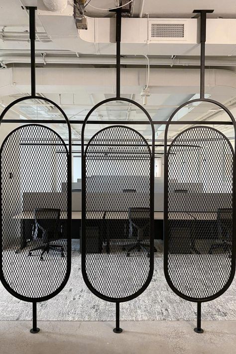 custom steel space divider in a pill shape and expanded metal infill Metal Screen Room Divider, Steel Room Divider, Room Divider Ideas Diy Cheap, Commercial Interiors Office, Metal Mesh Screen, Office Dividers, Metal Room Divider, Decorative Room Dividers, Modern Room Divider