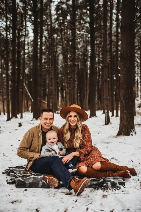 peoria IL family photos-family sits in snow with tall trees Cute Winter Family Picture Ideas, Cold Family Photoshoot, Christmas Family Photos Snow, Family Photos Snow Outdoor, Family Photos In Winter, Family Christmas Pictures Snow, Family Photos With Baby Winter, Outdoor Winter Photos, Cold Family Photos