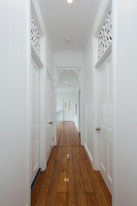 A beautifully renovated Queenslander home hallway featuring heritage breezeways and archways. #queenslanderhouse #queenslanderstyle #queenslanderhome #queenslander #queenslanderrenovation #brisbanerenovation Coastal Flooring Ideas, Queenslander Homes Interior, Queenslander Homes Exterior, Renovated Queenslander, Queenslander Architecture, Queenslander Renovation, Queenslander House, Home Hallway, Weatherboard House