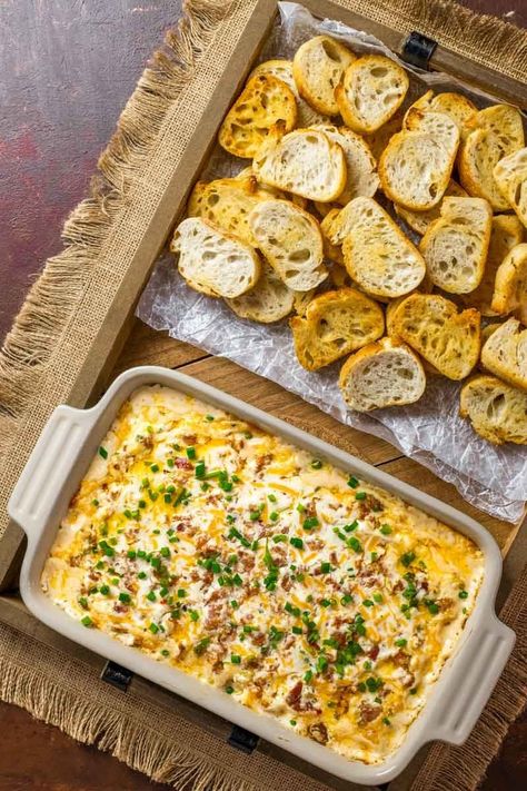 Boudin Dip! This Louisiana-inspired Boudin dip is baked hot and bubbly with spicy Boudin Cajun sausage, a mix of cheeses, and sour cream. Perfect for parties or game day! | HomemadeHooplah.com Boudin Dip Recipe, Boudin Dip, Cajun Appetizers, Boudin Recipe, Mardi Gras Party Food, Boudain Recipes, Cajun Sausage, Mardi Gras Food, Cajun Dishes