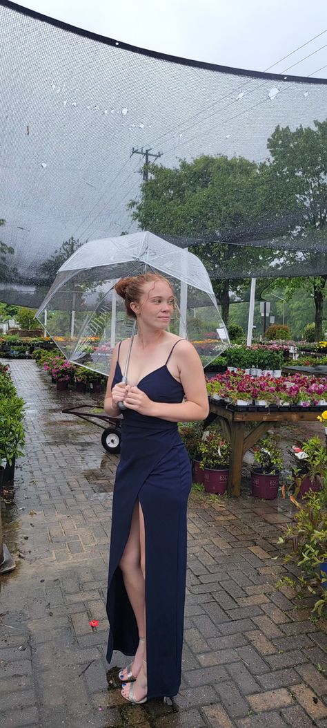 Girl standing outside of a greenhouse in the rain for prom pictures posing with an umbrella Raining Prom Pictures, Prom Pictures In The Rain, Rainy Day Prom Pictures, Rainy Birthday Party Ideas, Rainy Graduation Pictures, Rainy Prom Pictures, Pictures In The Rain, Prom Picture Ideas, Rainy Day Pictures