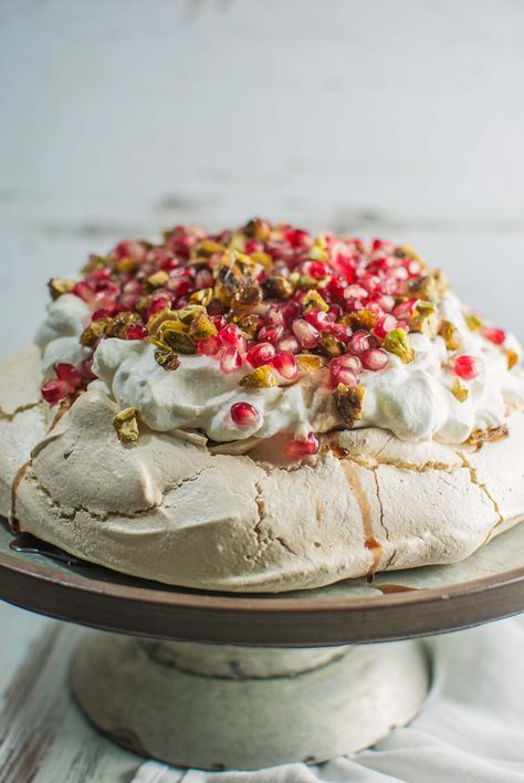 With scattered pomegranate seeds, and topped off with pistachio brittle and plenty of cardamom scented cream! 27 JAN 2017 Rhonda and Mira Winter Pavlova, Australian Pavlova, Pavlova Toppings, Pistachio Brittle, Christmas Pavlova, Chocolate Pavlova, Pavlova Dessert, Pavlova Cake, Mini Pavlova