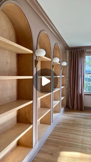 Jourdan Fairchild on Instagram: "These living room bookshelves were a *true* labor of love, and here’s digestible glimpse of what it took to build them from scratch.✨  1. We removed the original crown molding and baseboards.  2. After transporting 192,192,827 boards on top of our small SUV (#weneedatruck), Andrew built the basic framework for the shelves.  3. He extended an electrical outlet from the floor board so we could later install three sconces between the four bookshelves. That part still amazes me, tbh.  4. After much trial and error, we realized it’d be best to build the actual birch bookshelf boxes outside and then bring them in. It’s an old house, this wall bows a bit, and this reframing (ha) would give us that beautiful continuous wood piece along the back of each shelf.  5. I Built In Bookshelves With Sconces, Built In Bookshelves Half Wall, Built In Arch Bookcase, Diy Wood Bookcase, How To Build Bookshelves, Built In Floor To Ceiling Bookshelves, Wooden Built In Bookshelves, How To Build A Bookshelf Wall, Birch Bookshelf