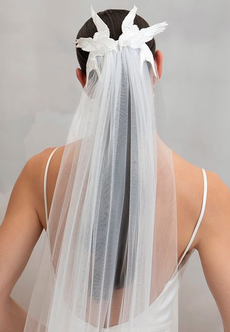 The chapel length Avain Veil is the perfect statement-making accessory for the daring romantic bride. Beautifully embroidered birds frame the back of the head as they 'kiss' while a soft layer of oyster tulle cascades down from underneath them. The veil effortlessly slides into the back of your hairstyle with a metal comb. Styled here with the Lipsy Gown. Birdcage Veil With Long Dress, Bridal Veil Vines, Bridal Veil With Hair Piece, Wedding Hats For Bride Veil, Non Bridal Veil, Neck Collar Vail Wedding Dress, Bridal Accessories Wedding Dress, Embroidered Wedding Veil Flower, Wedding Dress Assessories