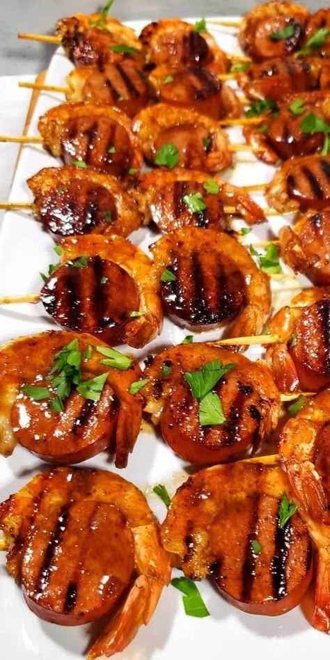 These Glazed New Orleans BBQ Shrimp & Sausage Kabobs are kind of magical because they disappear before your eyes. I'm not kidding I set these out for a party and poof gone, all gobbled up. #creole #NewOrleans #shrimp #sausage #kabobs #appetizers #partyfood Bbq Shrimp And Sausage Skewers, Shrimp And Sausage Kabobs On The Grill, Shrimp And Sausage Appetizer, Shrimp Birthday Party, Seafood Bbq Ideas, Cajun Kabobs, New Orleans Appetizers, Grill Kabobs, New Orleans Bbq Shrimp