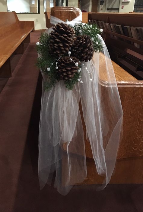 The pew bows from Eric and Nikis wedding. We used 6 layers of tool, fir bows, pinecones, and wire peal beads. Oregon Winter Wedding! Winter Pew Decorations Wedding, Winter Pew Decorations, Wedding Isles Decoration Winter, Winter Wedding Isles Decoration Outdoor, Christmas Wedding Pew Decorations, December Wedding Ceremony Decor, Winter Wedding Pew Decorations, Winter Church Decor, Pine Cone Centerpiece Wedding