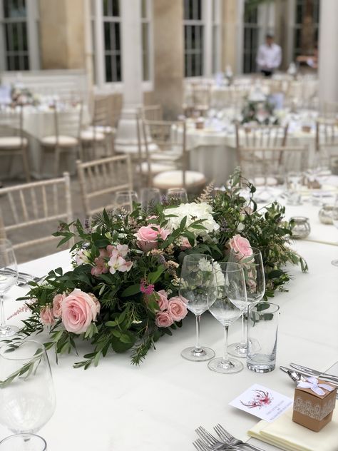 Soft and pretty top table arrangement for an oval table at syon Park Oval Top Table Wedding Flowers, Bridal Table Flowers Arrangements Long, Dinner Table Flowers Centerpiece Ideas, Wedding Flowers For Long Tables, Low Floral Arrangements For Table, Flower Centrepiece For Round Table, Long Table Centerpieces Wedding Floral Arrangements, Long Floral Centerpiece Wedding, Oval Floral Arrangement