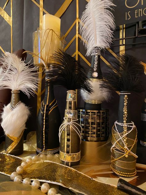 Wine and beer bottles spray painted and decorated for Gatsby Speakeasy Prohibition Party Speakeasy Decorations Diy, 1920s Bar Decor, 1920s Speakeasy Aesthetic Party, Speak Easy Decorations, 1920s Decor Party, 1920s Backdrop, 20’s Theme Party, Diy Gatsby Party, Speak Easy Party Decor