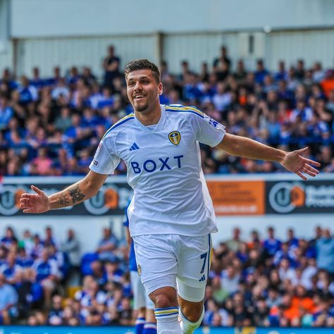 Striker Joel Piroe celebrates scoring a goal, running towards the camera in the Leeds United white kit with his arms outstretched and with a broad smile on his face. Leeds United Wallpaper, Chelsea Wallpapers, Leeds United Football, United Wallpaper, Leeds United Fc, Leeds United, Latest T Shirt, West Yorkshire, Free Prints