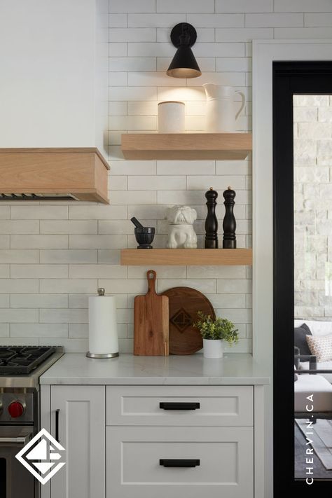 White oak floating shelves next to a range hood in a white modern farmhouse kitchen. White Modern Farmhouse Kitchen, White Oak Shelves, Teal Island, White Modern Farmhouse, Kitchen Floating Shelves, Kitchen Cabinet Layout, Glass Cabinets, Custom Range Hood, Modern Farmhouse Kitchen