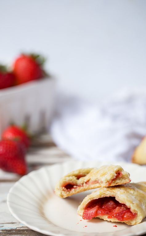 An easy two ingredient filling and a sturdy but flaky crust make these portable Strawberry Lemonade Hand Pies a hit at all your summer occasions! #strawberries #strawberrylemonade #handpies #strawberrypie How to Make Hand Pies | How to Freeze Hand Pies | Strawberry Hand Pies | Lemon Hand Pies | Lemon Pastry from ONEarmedMAMA.com Lemon Hand Pies, Lemon Pastry, Strawberry Hand Pies, Portable Dessert, Trifle Pudding, Two Ingredient, Holiday Sweets, Delectable Desserts, Strawberry Lemon