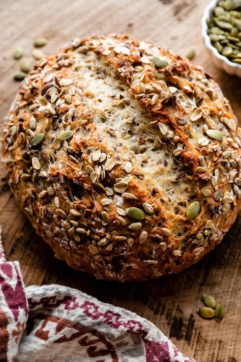 This no knead seeded oat bread is crusty on the outside, chewy on the inside, and has the most delicious crunch in every bite, thanks to 3 types of seeds. This is a hearty loaf of bread that doesn't require any kneading, and there's hardly any hands on work. Recipe on sallysbakingaddiction.com No Knead 5 Minute Artisan Bread, Easy Seed Bread Recipe, Dutch Oven Seed Bread, Seeded Oat Bread, Whole Wheat Seed Bread, No Knead Seeded Oat Bread, Whole Grain Dutch Oven Bread, Same Day Artisan Bread, First Watch Bread Recipe