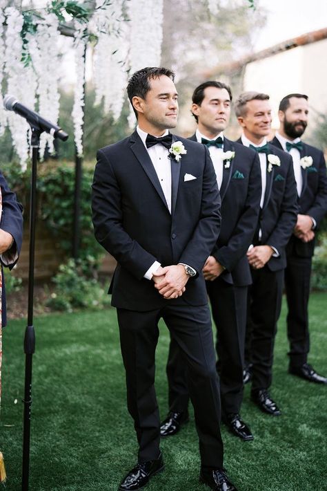 Sophisticated Lush Green & Classic White Wedding Black Suit With Green Bow Tie, Black White And Green Wedding Groomsmen, Black Tux Green Bow Tie, Black Suit Emerald Green Tie, Black Suit Green Accents, Black Tux Green Tie, Black Suit Green Bow Tie, Black Suit Green Tie, Groomsmen Attire Black