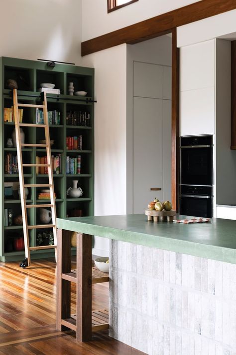 A green and timber kitchen with a coloured-concrete island bench and ceiling beams. Concrete Kitchen Island, Concrete Island, Concrete Tile Floor, Brunswick House, Kitchen Splashback Tiles, Ceiling Shelves, Timber Kitchen, Timber Shelves, Kitchen Island Bench