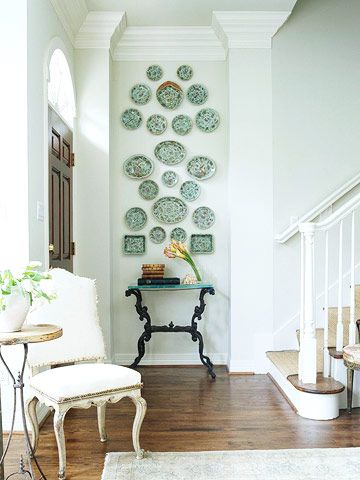 Work with the hanging space you have. Take a narrow wall and hang a tall vertical painting, or multiple smaller items such as these vintage plates. | bhg.com Small Hallway Decorating, Plate Wall Display, Plates On The Wall, Picture Gallery Wall, Plate Wall Decor, Plate Wall, Plate Decor, Small Hallways, Plate Display