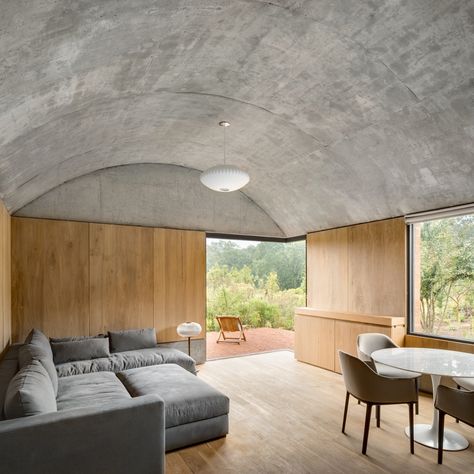 A family room caps the southern end of the bedroom wing and, as with all the bedrooms, features an exposed concrete barrel vault ceiling and opens up to an east-facing outdoor patio. #dwell #mexico #sustainablehomedesign Barrel Vault Ceiling, Living Photo, Neutral Interiors, An Architect, Home Modern, Furniture Layout, Sustainable Home, Vaulted Ceiling, Off Grid